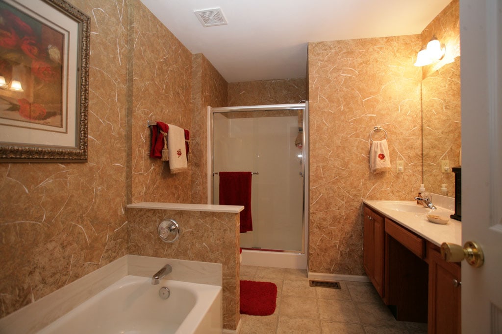 Master bathroom with faux finish wallpaper.