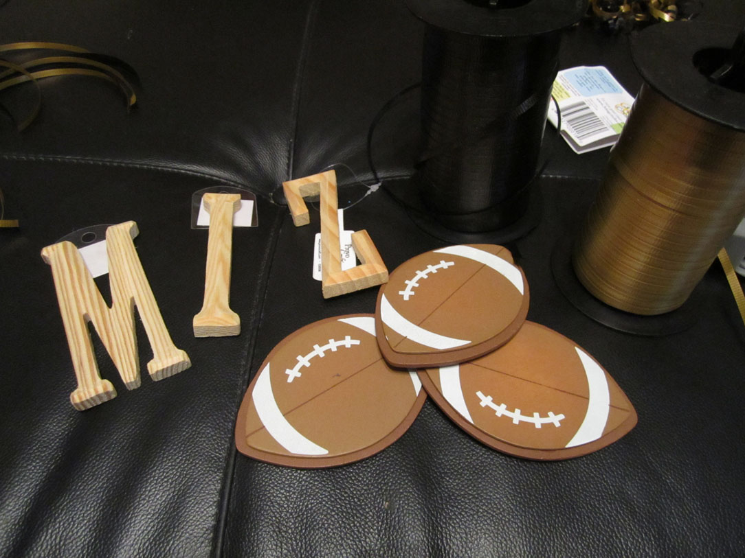 A cutout of footballs and the letters for the wreath.