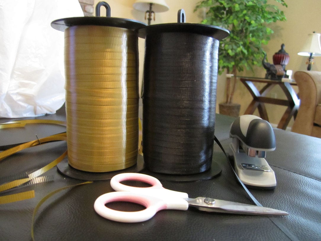 Black and yellow ribbon with scissors on the table.