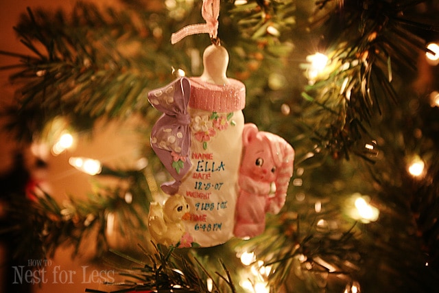 A baby bottle ornament on the tree.