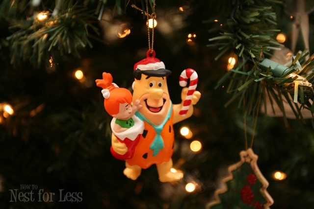 Fred Flintstone holiday ornament hanging on the Christmas tree.