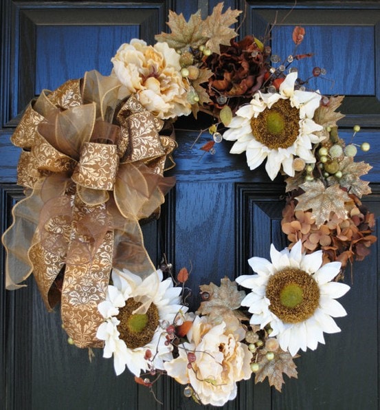 A white, gold, and amber holiday wreath on the door.