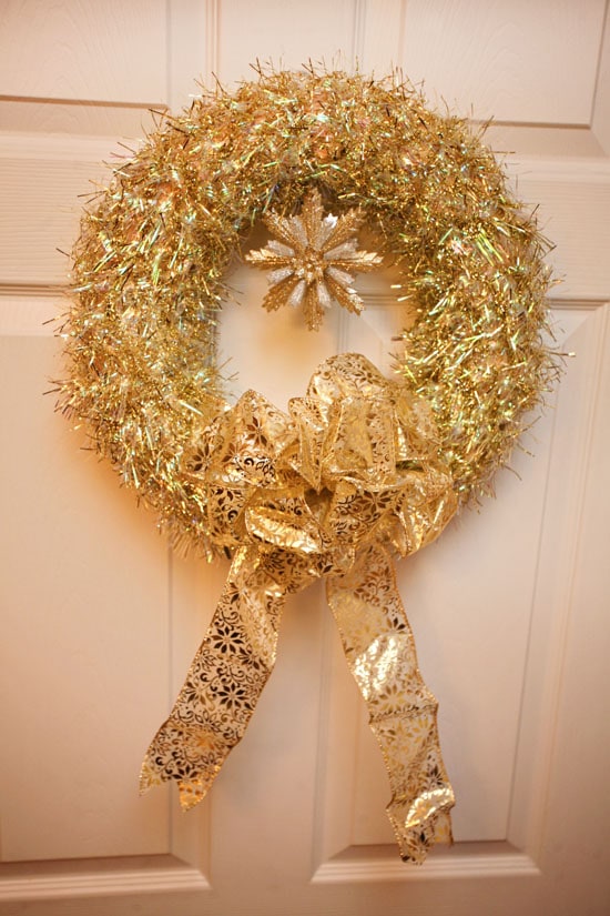 A gold tinsel wreath on the front door.