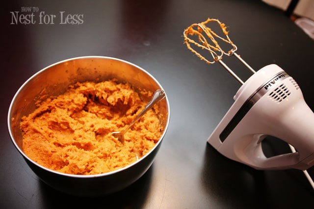 An electric mixer mixing all the ingredients in a bowl.