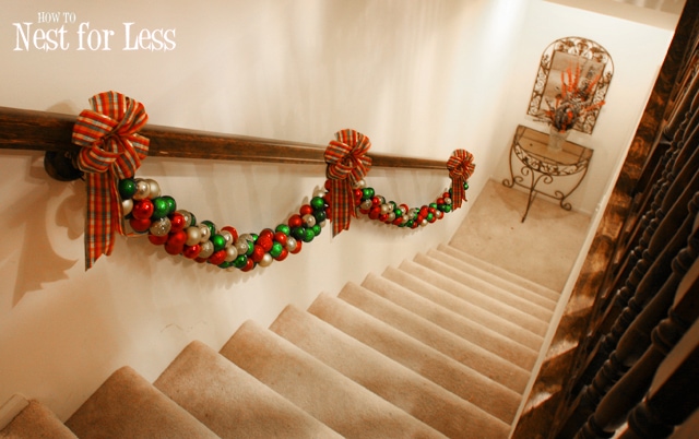 The garland and bows on the hand railing by the stairs.