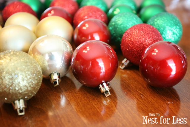 Gold, red, and green Christmas ornament lying on the ground.