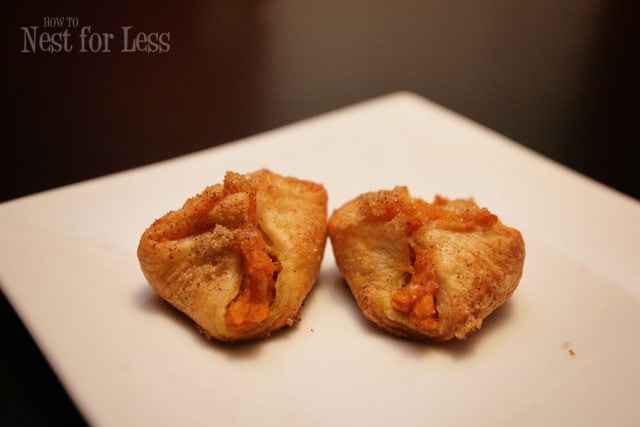 Two potato puffs on a white plate.