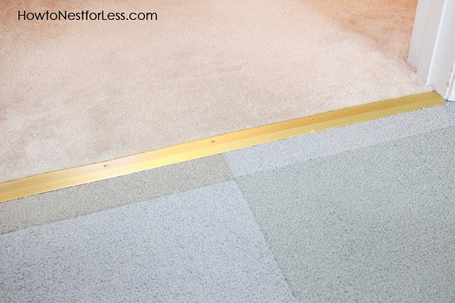 Gold metal carpet plate in between two rooms.