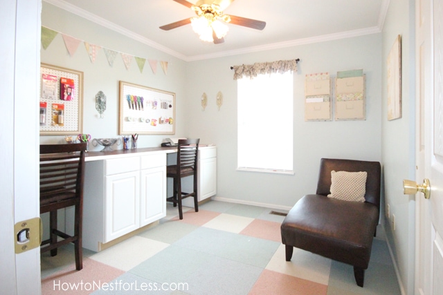 Craft room, with brown lounger in corner and window.