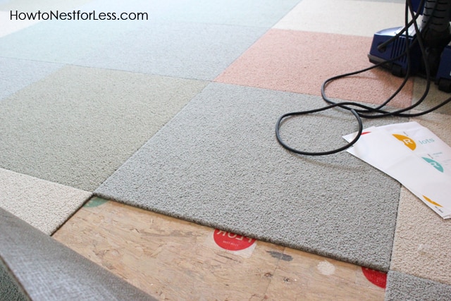 Laying down the floor tiles in a pattern.