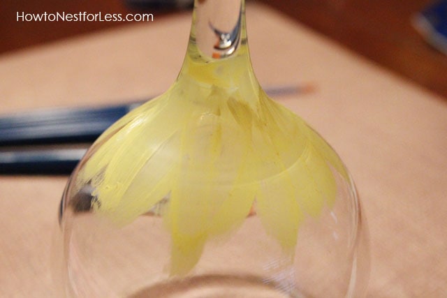 Yellow paint in the shape of a flower on the wine glass.