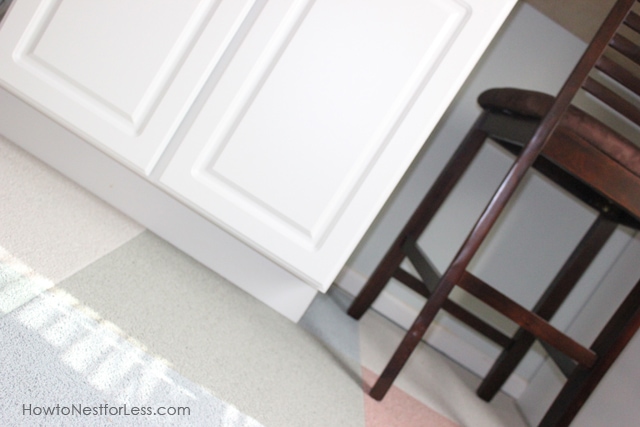 Adding the white trim to the bottom of the desk and a brown chair near it.