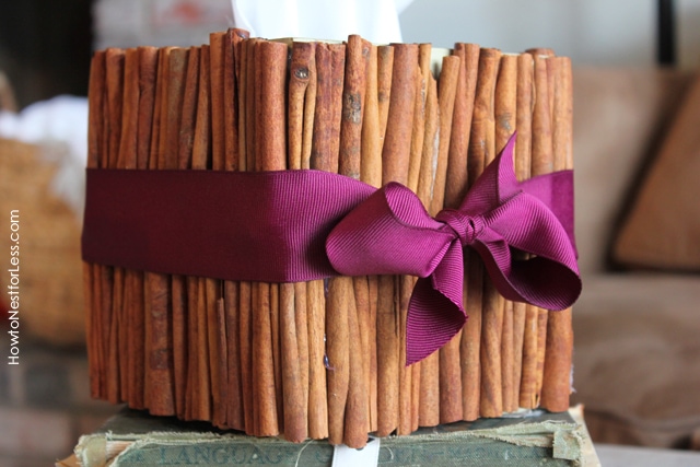 The cinnamon box on top of antique books on table.