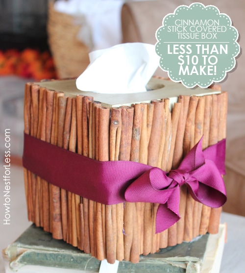 Cinnamon stick tissue box with a purple ribbon around it.