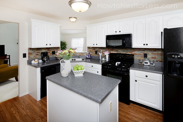 white kitchen cabinets with black appliances