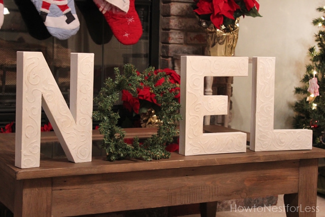 Noel spelled out on the table in front of the fireplace.