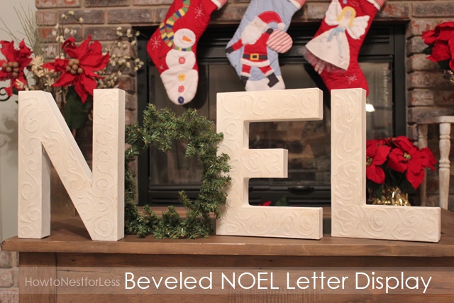 Noel sign on the mantel with Christmas stockings hanging above it.