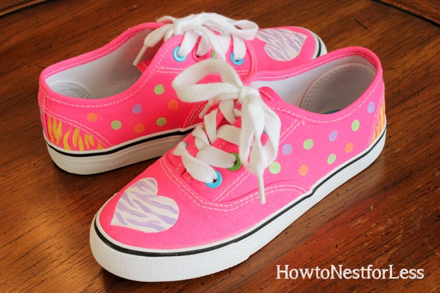 Painted hot pink tennis shoes with polka dots.