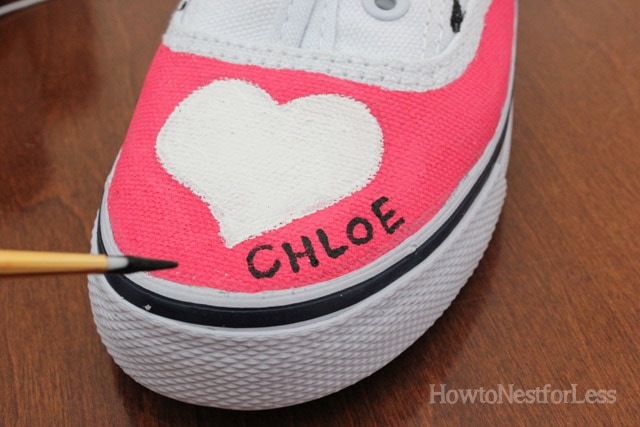 A white heart and a little girl's name Chloe on the shoe.