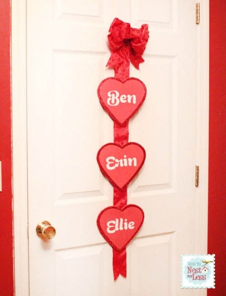 Foam Valentine's day hearts on a ribbon hanging on a door.