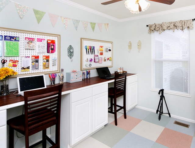 Craft room with desk and ceiling fan.