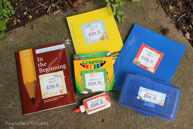 School books lying on the ground, with glue and markers as well.