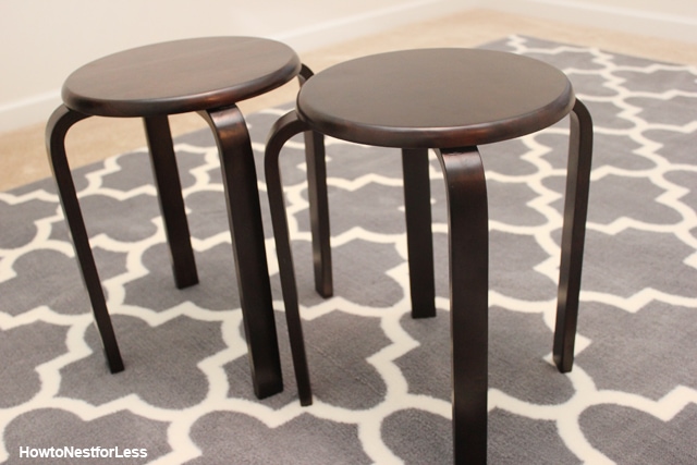 Two brown and metal stools before being stenciled.