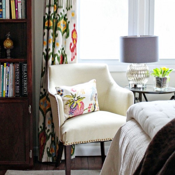 Lined multi coloured curtains hanging to the floor.