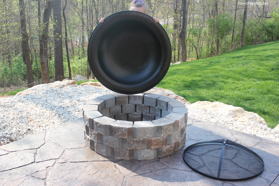 Holding the metal insert above the fire pit.