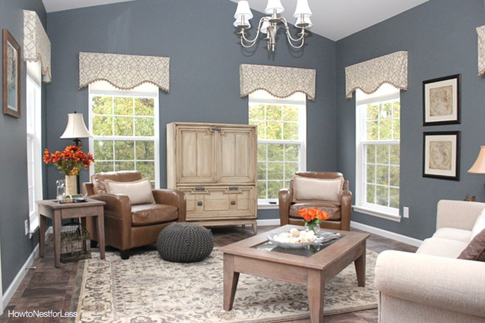 Blue sun room with neutral valance on the windows.