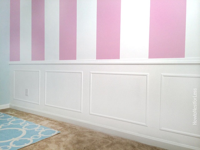 A wall with chair molding and picture frame molding on the lower portion.