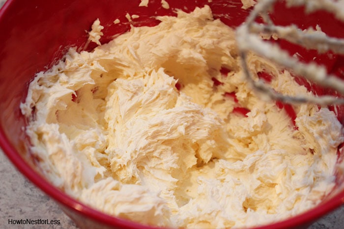 Mixing the wet ingredients in a red bowl.