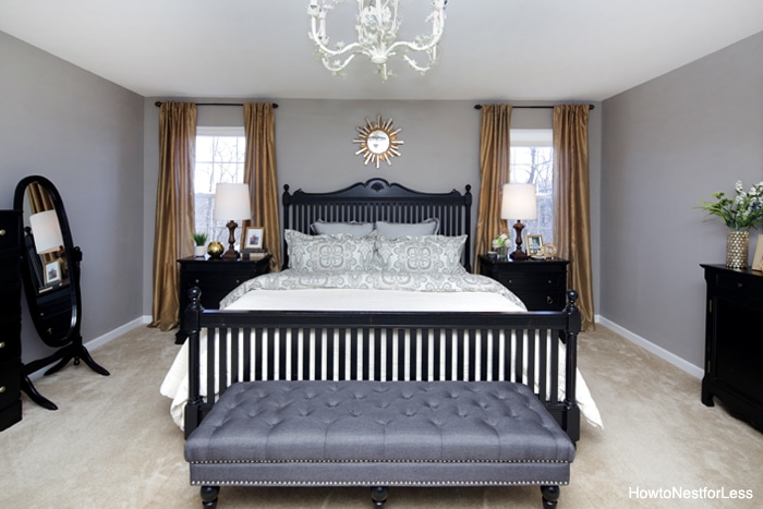 Grey charcoal bench at the foot of the bed.