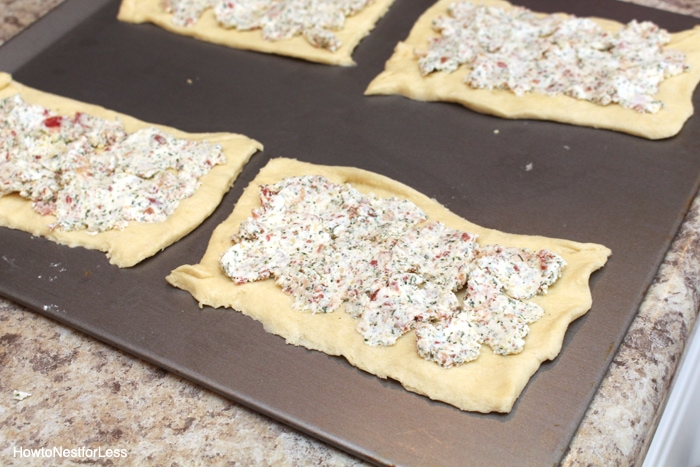 Spreading the mixture onto the pastry.