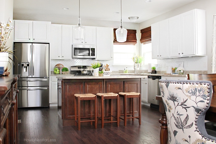 Dark wood and white kitchen with grey chair in dining room.