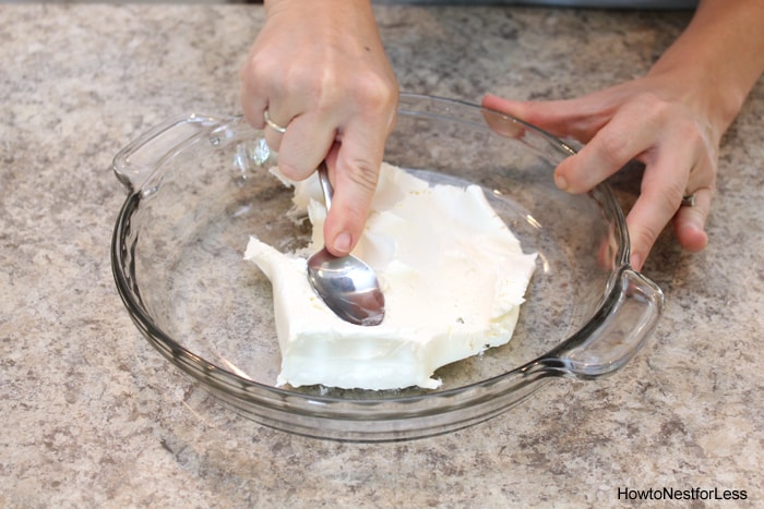 Putting the cream cheese in a glass pie plate.