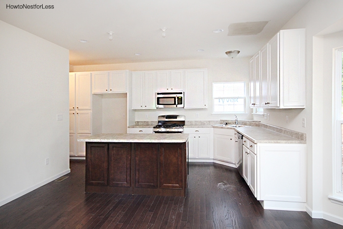 White kitchen before renovation with no furniture in it.