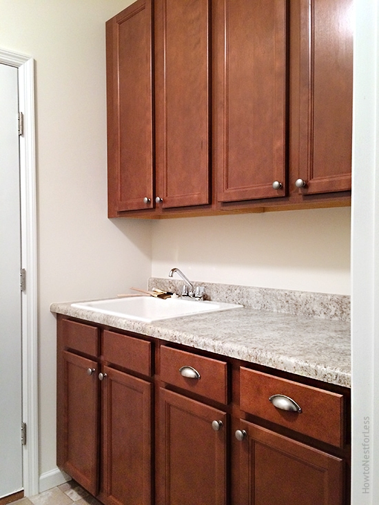 laundry room utility sink and cabinets