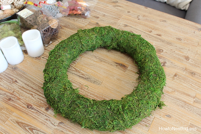 Pinning the moss to the wreath.