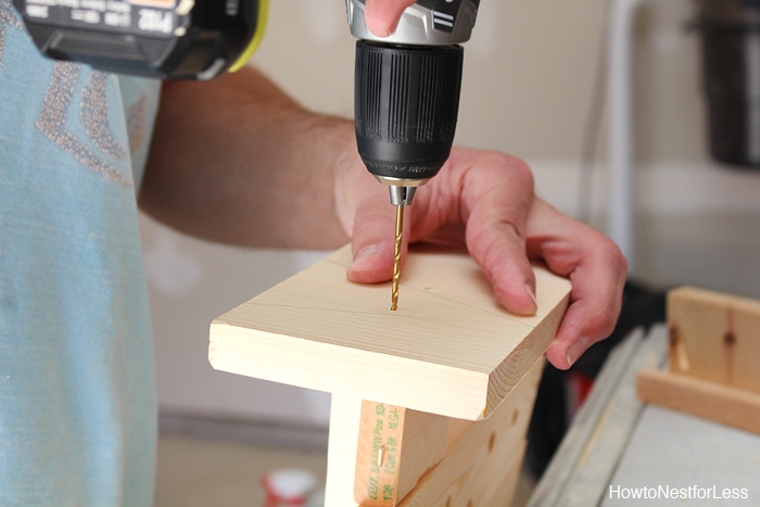 Drilling a hole into the base of the DIY Christmas tree.