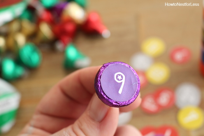 Gluing the numbers on the bottom of the Hershey's Kisses.