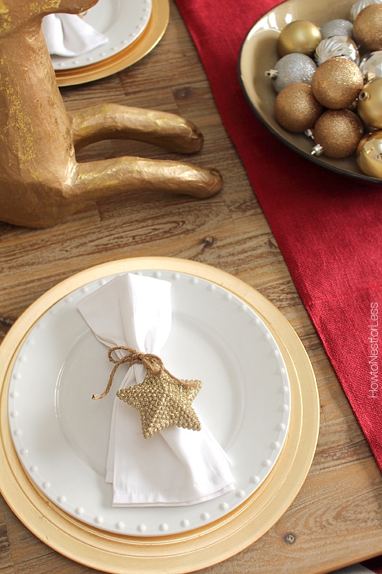 Tying the sparkly ornament on the napkin.