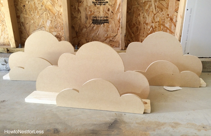 The cut out cloud shapes on floor of garage.