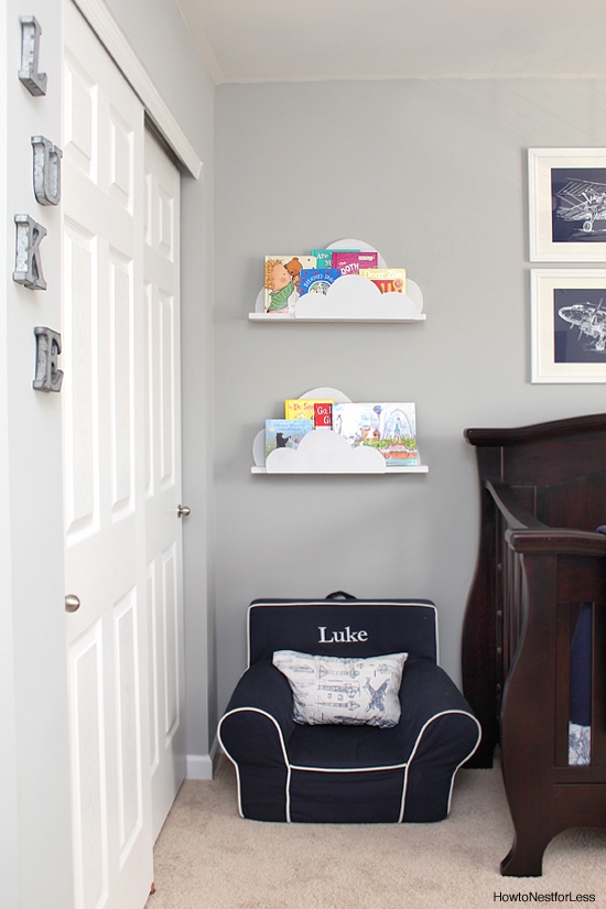 Cloud bookshelves on wall with children's books in them.