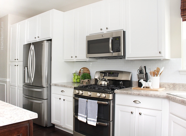 White kitchen with utensils on counter.