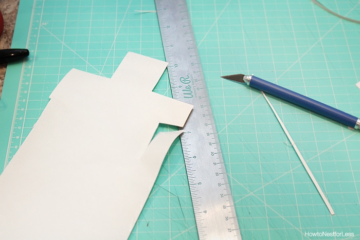 Ruler, exacto knife and tiles on the cutting mat.