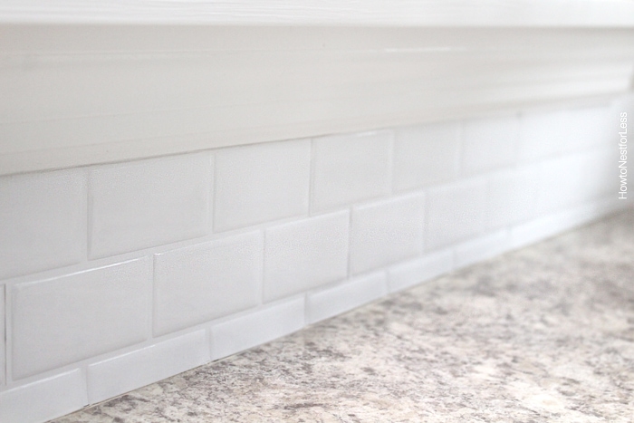 White self adhesive tiles in kitchen.