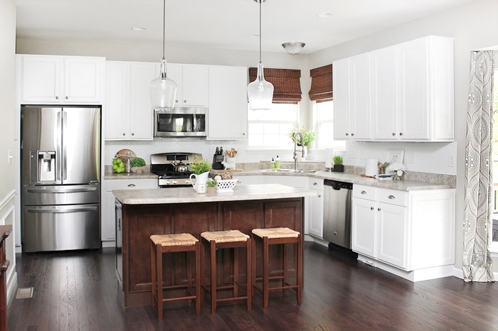 White cabinets and a dark floor in kitchen.