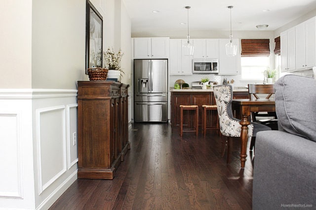 Kitchen with darker wood flooring, buffet, and kitchen island.