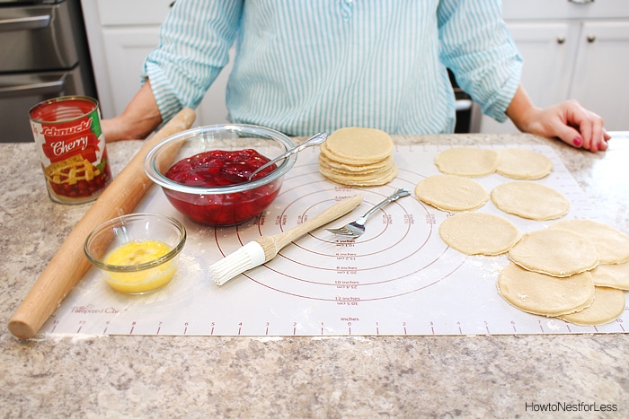 The dough circles and cherry pie filling and a pastry brush.